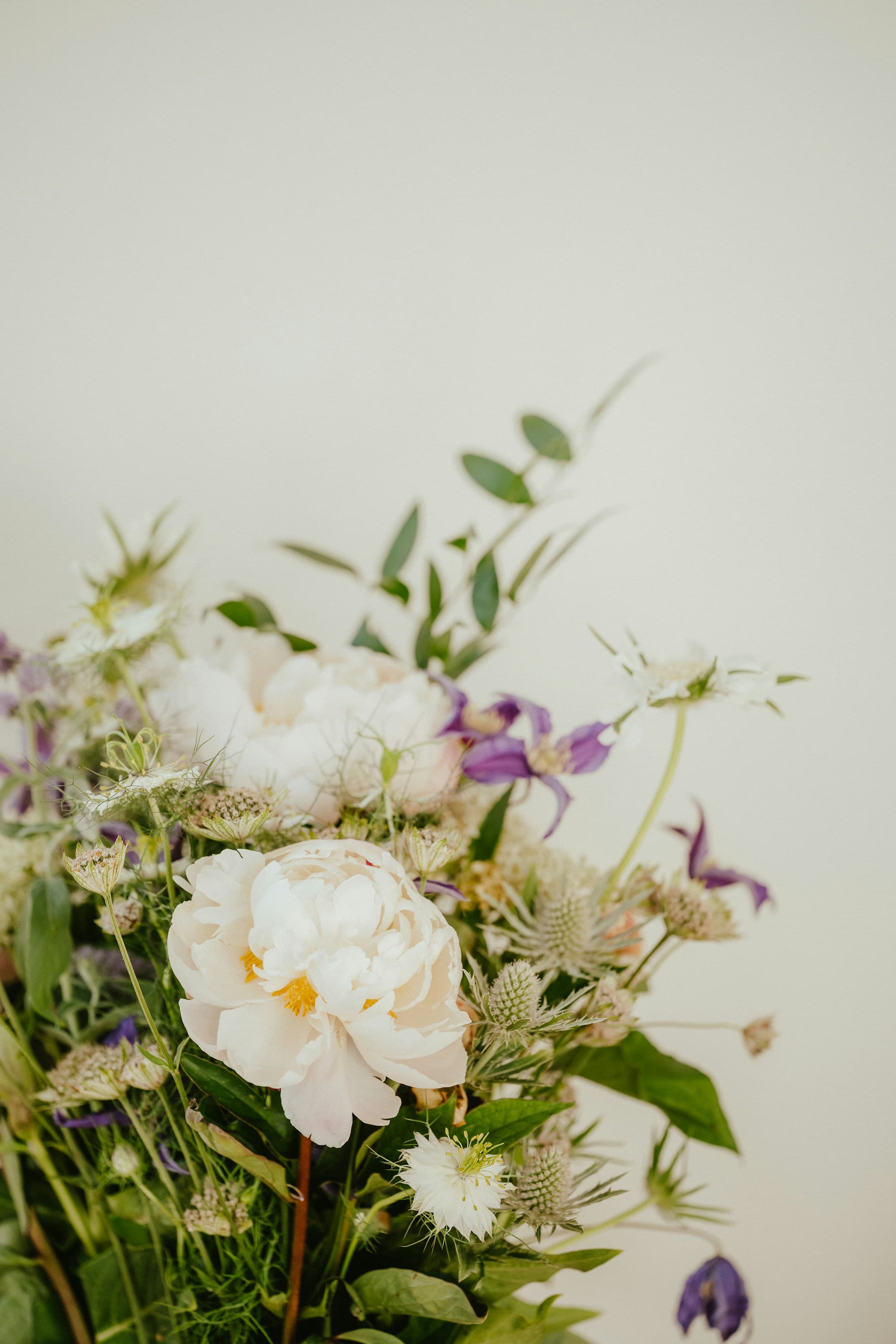 A loose seasonal bouquet on a kitchen counter in soft daylight