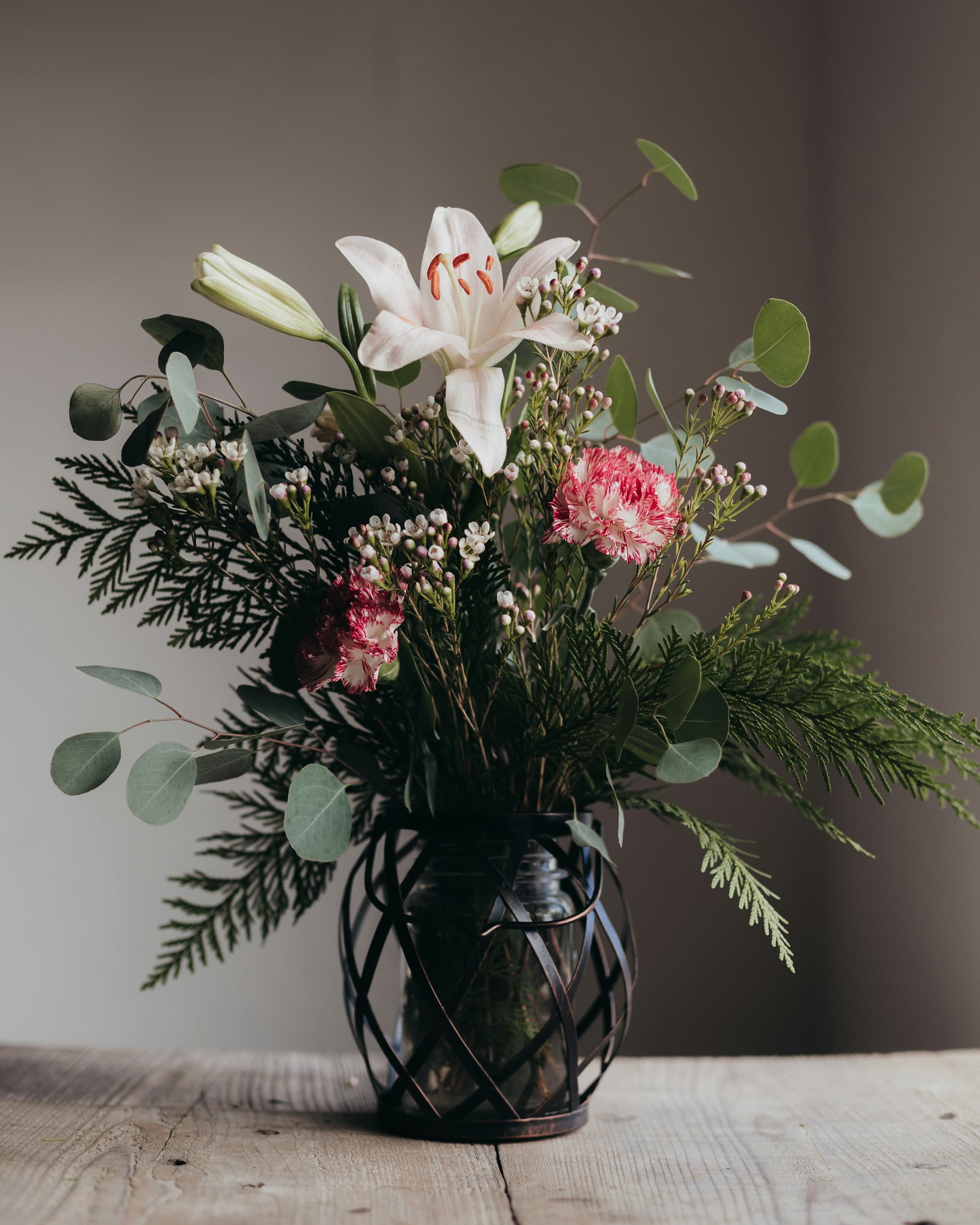 A vase of seasonal flowers in soft light